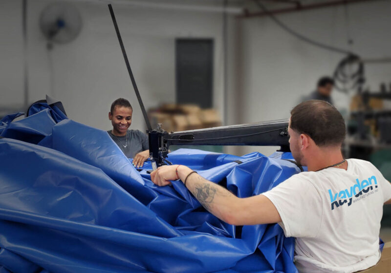 A picture of a manufacturing team building the seams on a pool safety cover