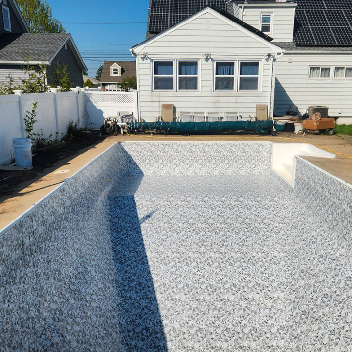 A picture of a grey clean pool liner without water in the pool