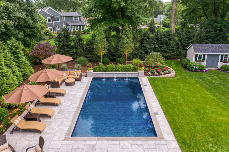 An aerial picture of a pool in a backyard