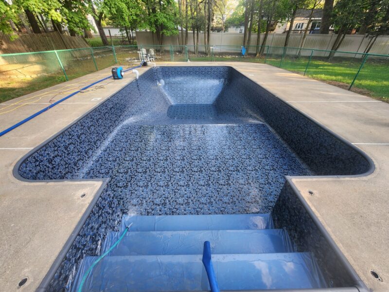 A picture of a vinyl liner pool without water in it