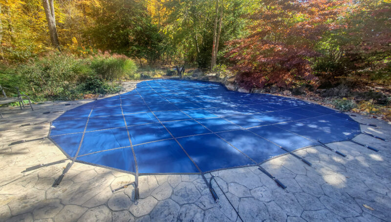 A picture of a blue safety cover with trees in the background