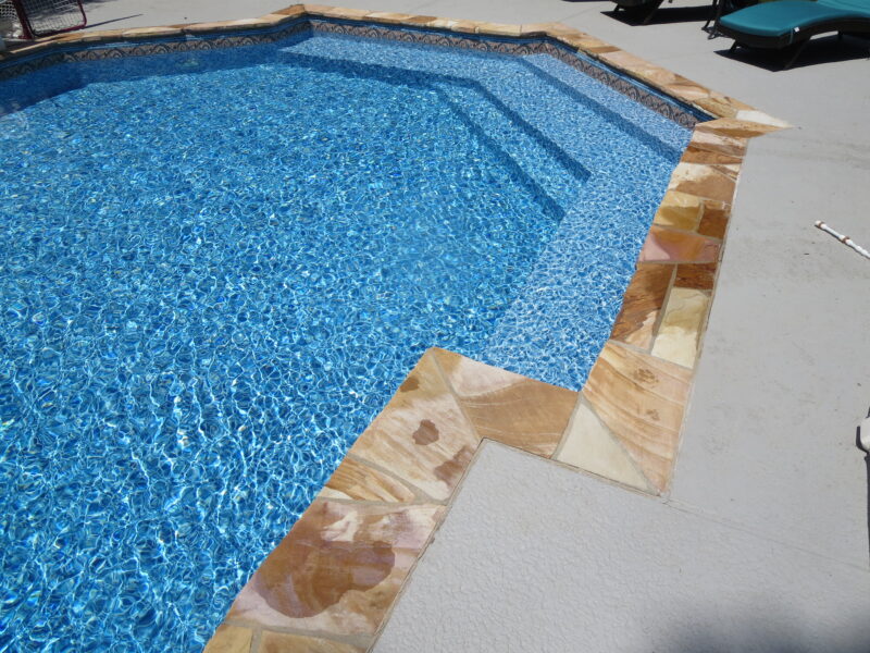 A close-up of the perimeter of a vinyl liner pool