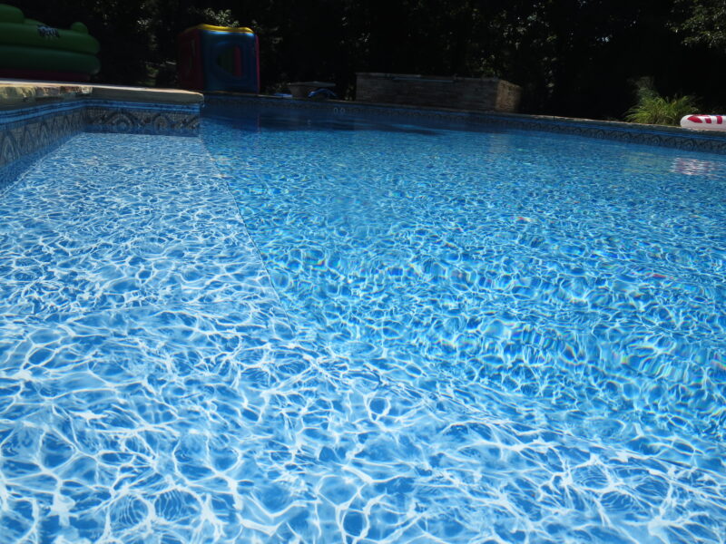 A picture of a vinyl liner pool with the floor pattern up close