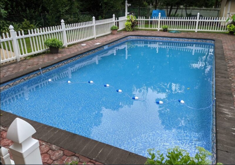 A rectangular vinyl liner pool in a backyard