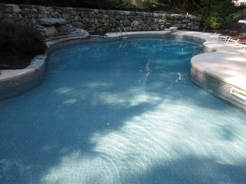 A picture of a pool with a shadow draped across it