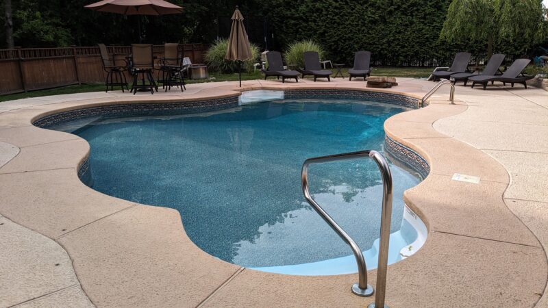 A picture of coping and pool steps around a vinyl liner pool