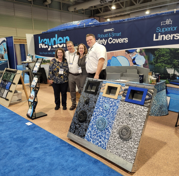 A picture of Jeff Kayden and Jim Dorsey smiling while selling pool products at a trade show